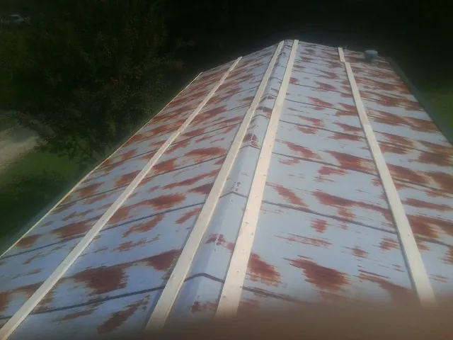 Rusted metal roof panels with new wood purlins before replacement — Storm Damage Roof Repair in Lagrangeville by Roofing Brothers